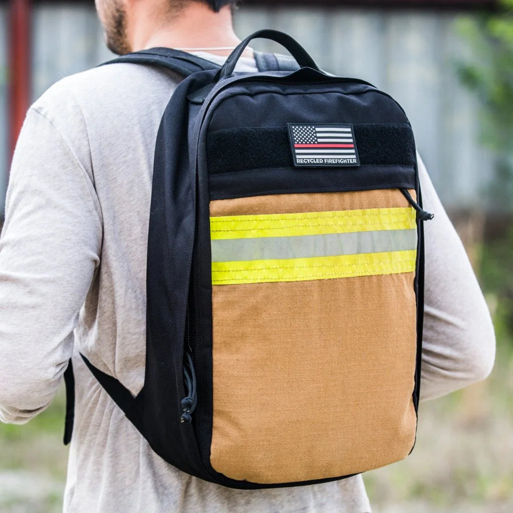 The Chief USA-made tactical backpack by Recycled Firefighter featuring a high-visibility yellow repurposed firefighter bunker gear front panel.