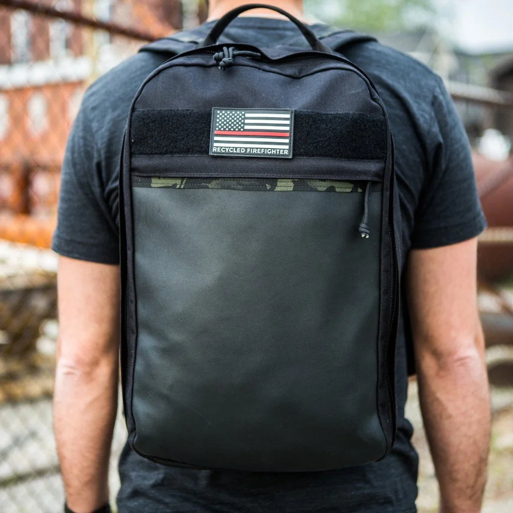 The Chief tactical backpack from Recycled Firefighter featuring durable black combat leather and MultiCam Black webbing.