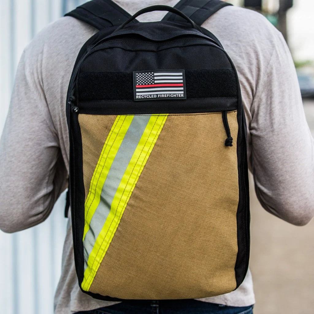 The Chief USA-made tactical backpack by Recycled Firefighter featuring a high-visibility yellow repurposed firefighter bunker gear front panel.