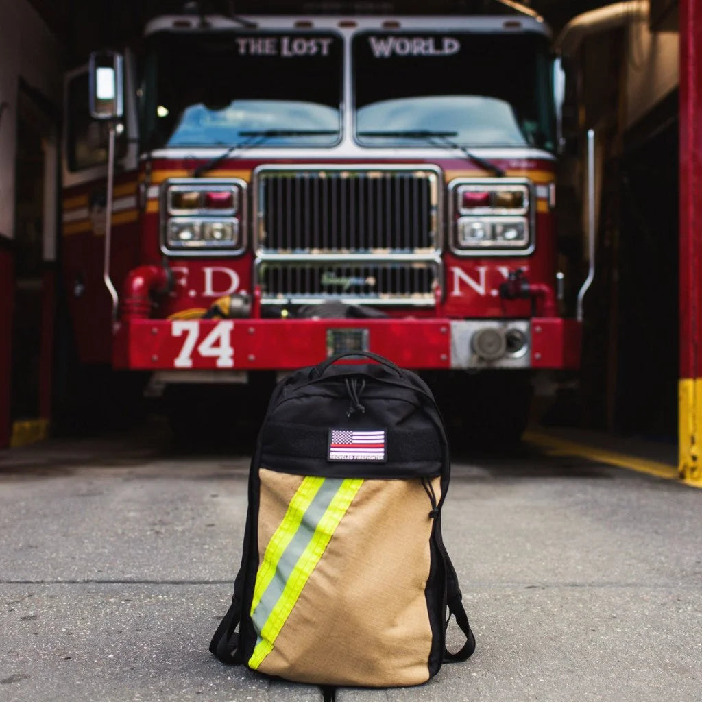 The Chief USA-made tactical backpack by Recycled Firefighter featuring a high-visibility yellow repurposed firefighter bunker gear front panel.