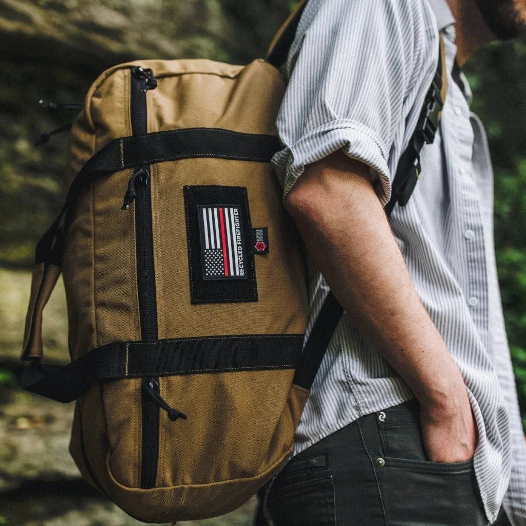 The Recycled Firefighter 72 Hour Duffle Backpack in coyote tan with black accents provides a rugged, desert-style look.