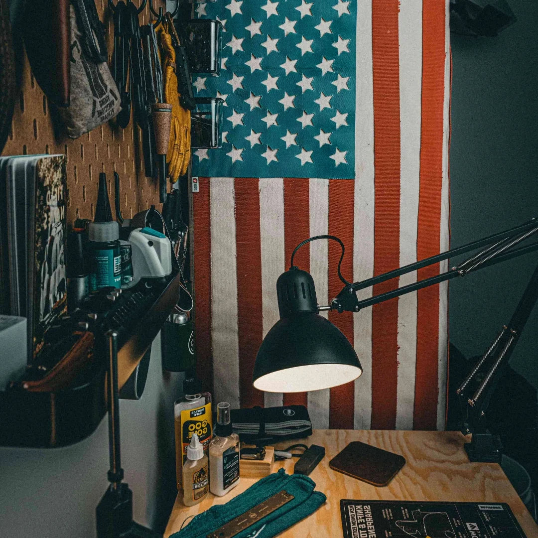 A large American flag by Recycled Firefighter handcrafted from decommissioned 5-inch fire hose with a Coyote Arid border and four brass mounting grommets.