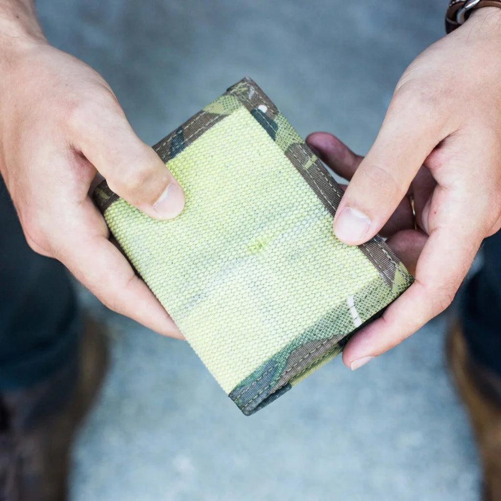 "The Captain" by Recycled Firefighter is a rugged bifold wallet handcrafted from decommissioned fire hose for maximum durability. Its slim, wide-profile design features a clear ID window and is built to lay flat in your pocket.