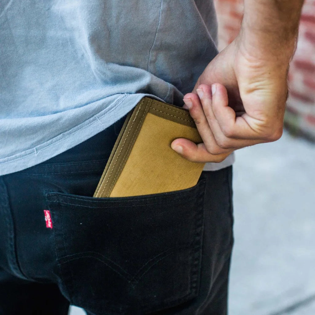 "The Captain" by Recycled Firefighter is a rugged bifold wallet handcrafted from decommissioned fire hose for maximum durability. Its slim, wide-profile design features a clear ID window and is built to lay flat in your pocket.