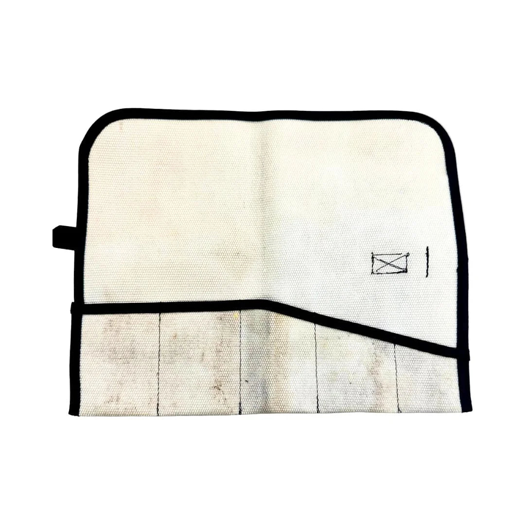 Recycled Firefighter Fire Hose Tool Roll in Vintage White, made from decommissioned double-jacketed fire hose. The design includes heavy-duty internal sleeves and a steel cinch buckle for professional tool organization.