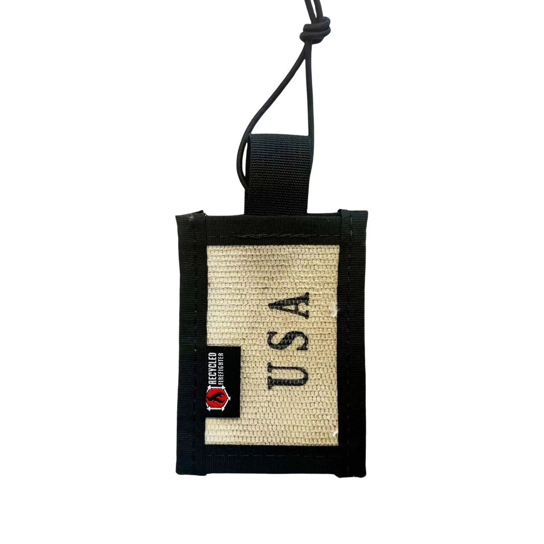 White decommissioned firehose luggage tag featuring durable nylon edges and elastic shock cord by Recycled Firefighter.