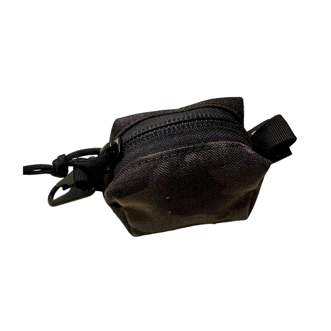 The Recycled Firefighter Hot Shot Keychain Pouch is a compact, USA-made tactical accessory featuring heavy-duty nylon, a secure zipper, and a metal clip for organizing small everyday essentials.