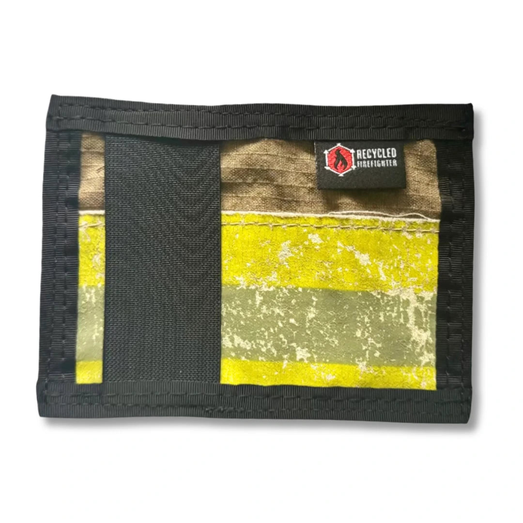 A tan bifold Rookie Wallet from Recycled Firefighter, handmade from authentic repurposed firefighter bunker gear with a signature high-visibility reflective stripe.