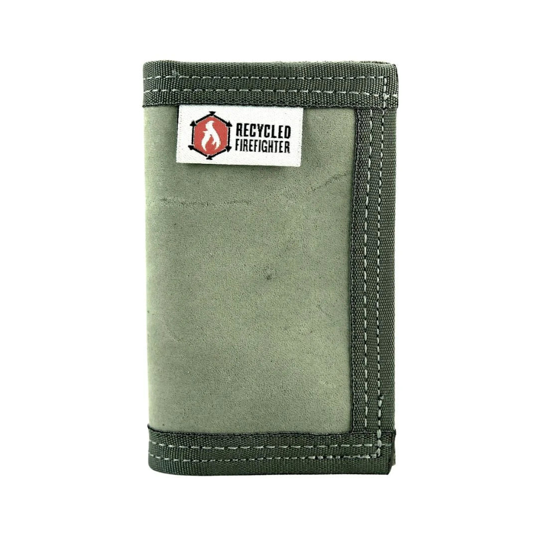 A slim, black bifold 'Rookie' wallet by Recycled Firefighter, handcrafted from rugged repurposed U.S. Military combat boot leather with a black elastic cash strap.
