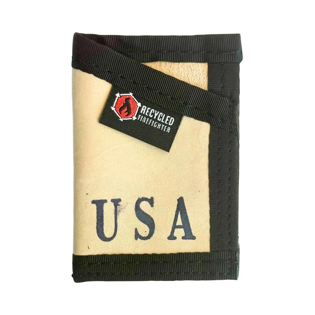 A premium Leather Tan Sergeant Wallet by Recycled Firefighter featuring a sleek black elastic strap for a classic finish.