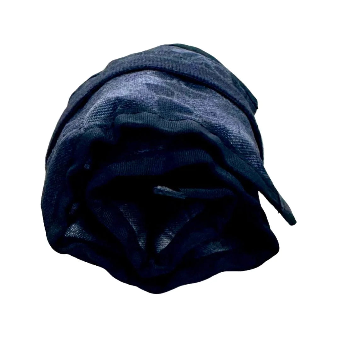 The Recycled Firefighter Small Tool Roll cinched tightly with a wrap-around hook strap, showcasing its slim, portable design for travel and field use.