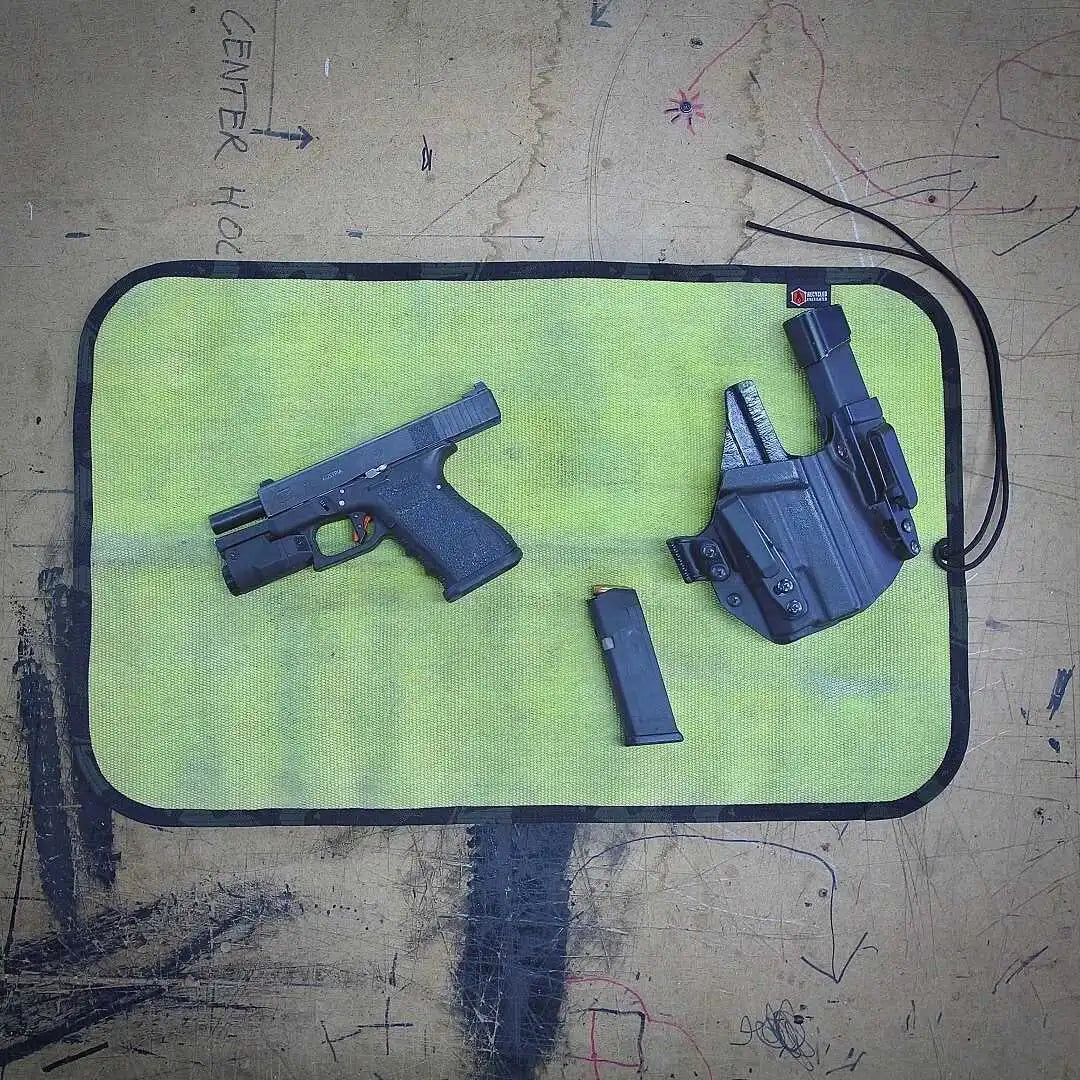 Yellow Black Variant A rugged Yellow Black Drop Zone Mat from Recycled Firefighter featuring a yellow repurposed firehose surface and black 1000D nylon backing. The mat is laid flat to provide a durable workspace for cleaning tools or organizing gear.