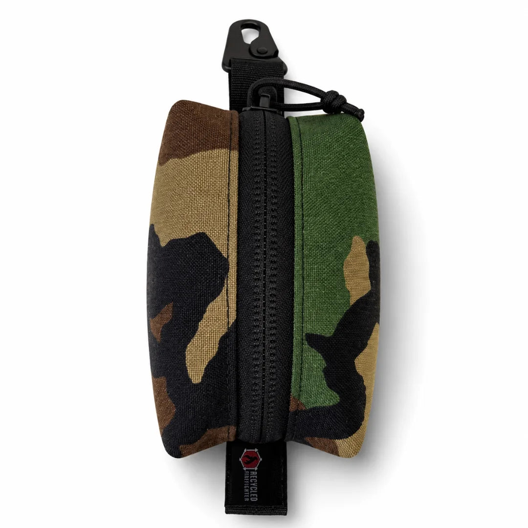 Recycled Firefighter's Hot Shot Commander Keychain Pouch in classic Woodland camo delivers a timeless military-style EDC organizer engineered for rugged everyday carry. Equipped with a heavy-duty zipper and metal clip, this USA-made keychain pouch keeps essentials safe and close at hand.