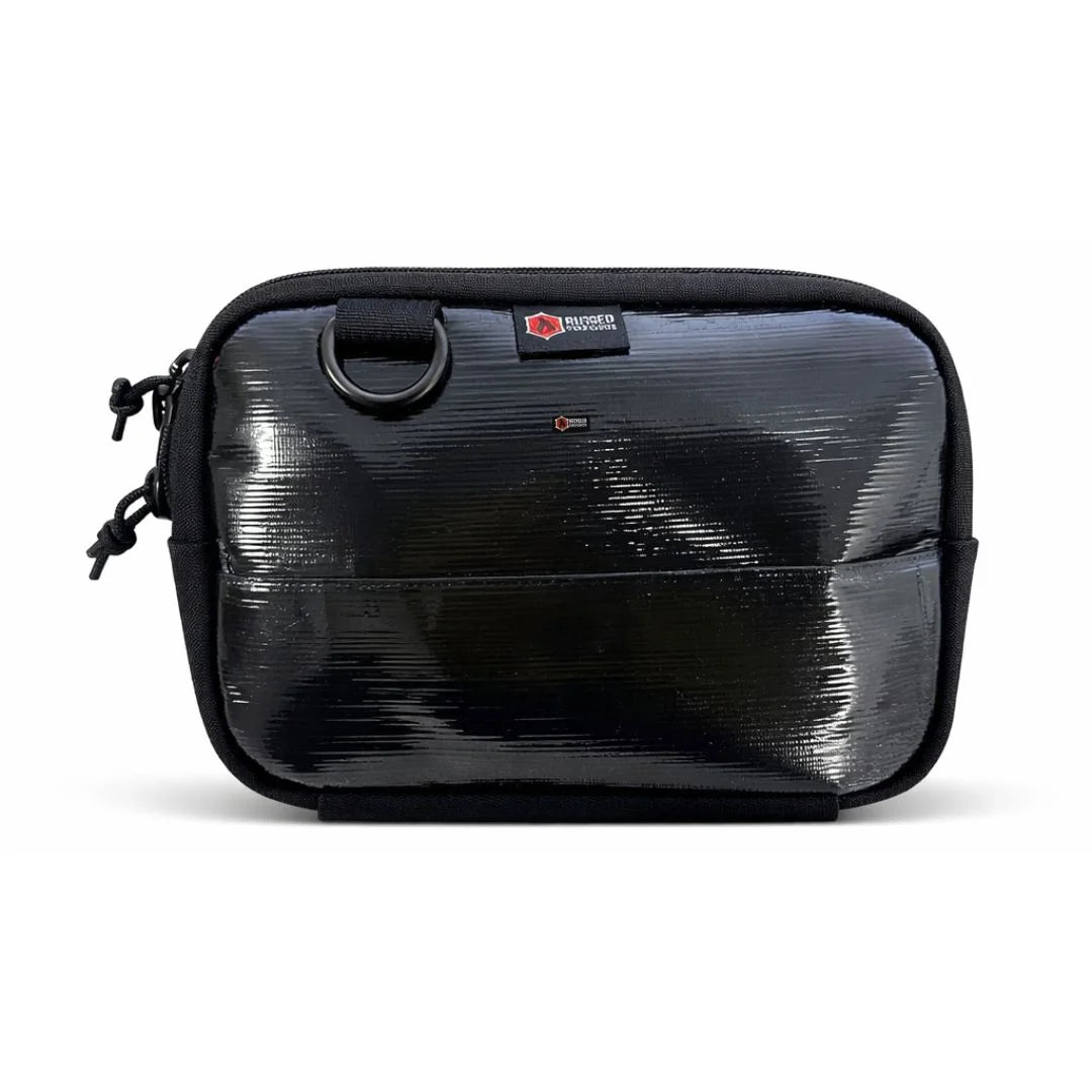 A sleek Black Rubber firehose fanny pack from Recycled Firefighter. Made from the internal lining of a decommissioned firehose, this variant has a smooth, semi-matte black finish that is highly water-resistant, featuring all-black hardware.