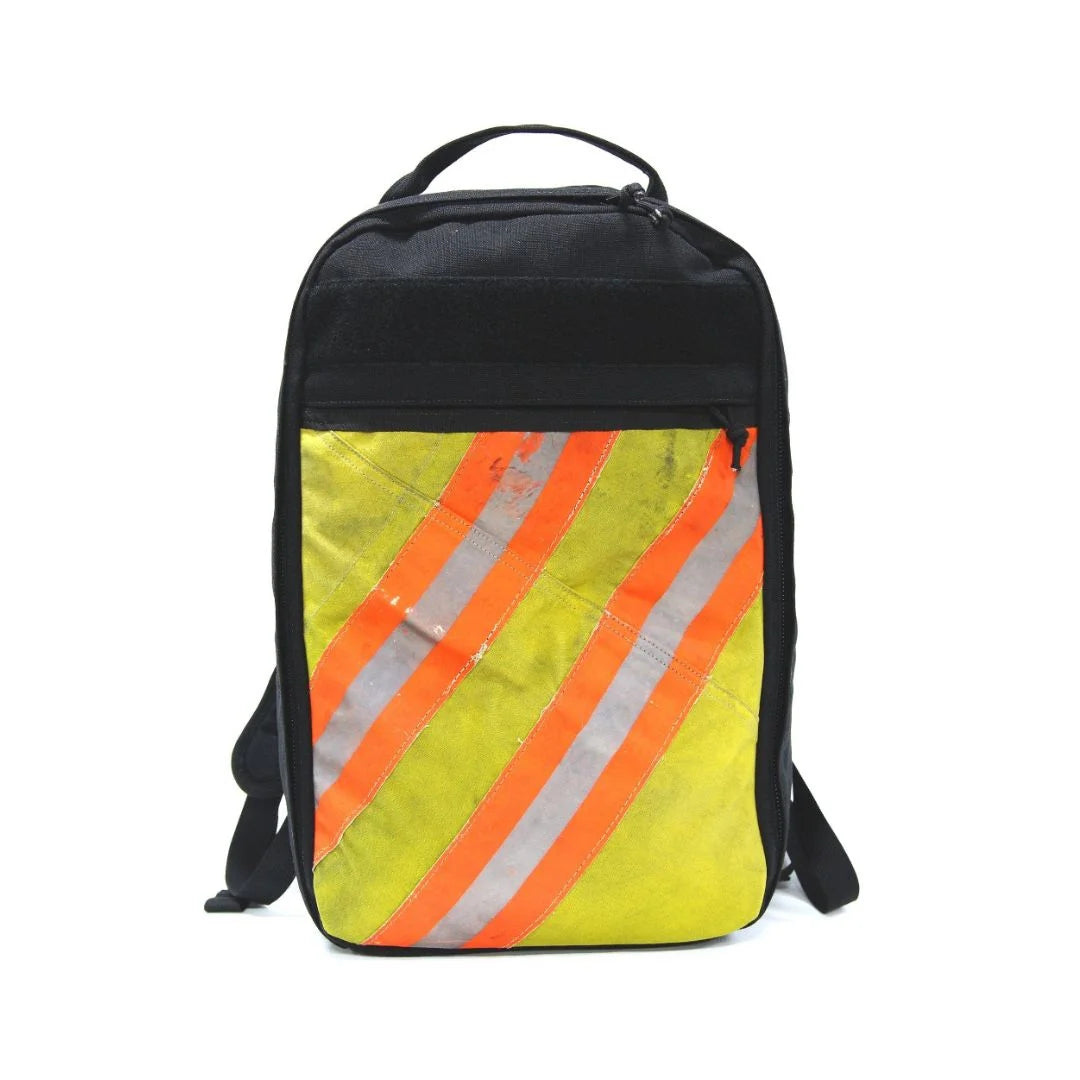 The Chief USA-made tactical backpack by Recycled Firefighter with a repurposed firefighter gear panel and reflective orange safety stripe.
