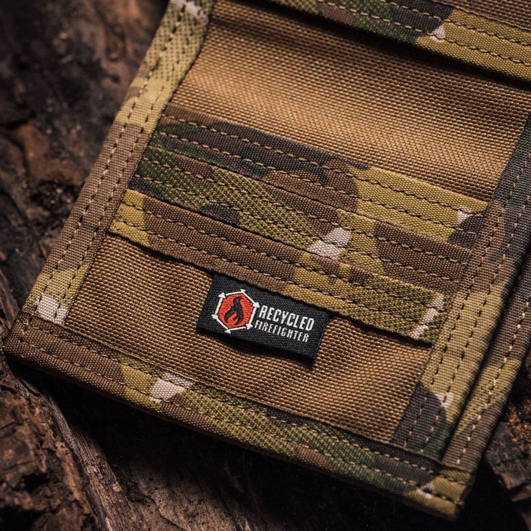 "The Captain" by Recycled Firefighter is a rugged bifold wallet handcrafted from decommissioned fire hose for maximum durability. Its slim, wide-profile design features a clear ID window and is built to lay flat in your pocket.