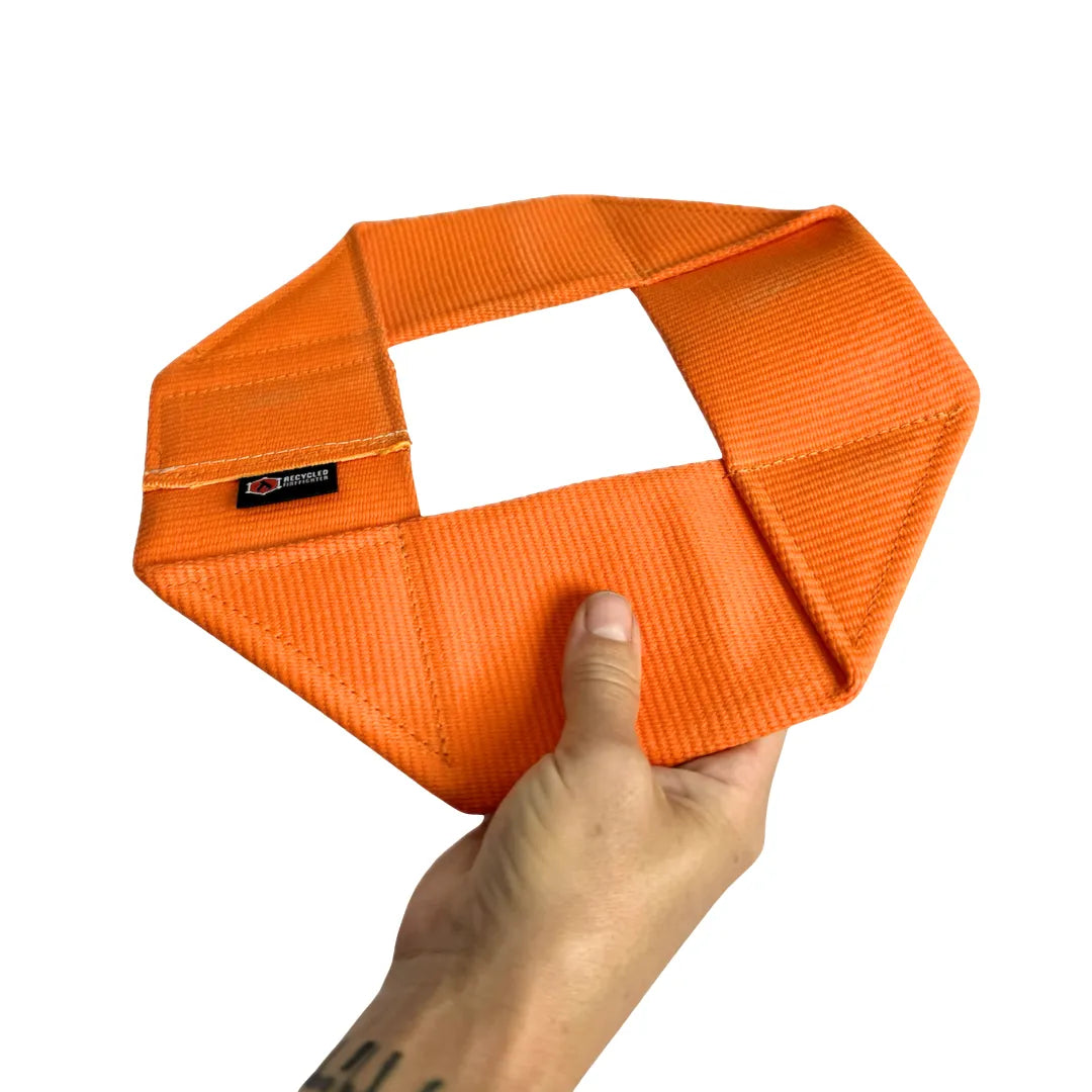 The Fire Hose Dog Frisbee in Orange by Recycled Firefighter. Tactical design meets professional durability standards.