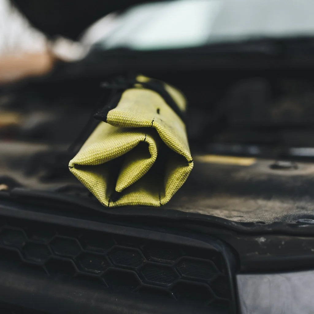 Vintage Yellow Fire Hose Tool Roll from Recycled Firefighter, showcasing the unique scuffs and character of real retired fire gear. This heavy-duty roll is box-stitched at all stress points to ensure a lifetime of reliable tool storage.