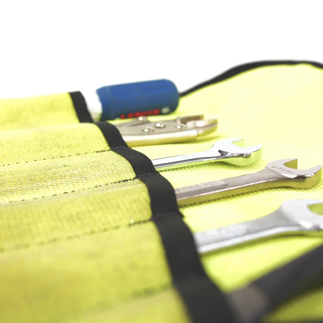 Vintage Yellow Fire Hose Tool Roll from Recycled Firefighter, showcasing the unique scuffs and character of real retired fire gear. This heavy-duty roll is box-stitched at all stress points to ensure a lifetime of reliable tool storage.