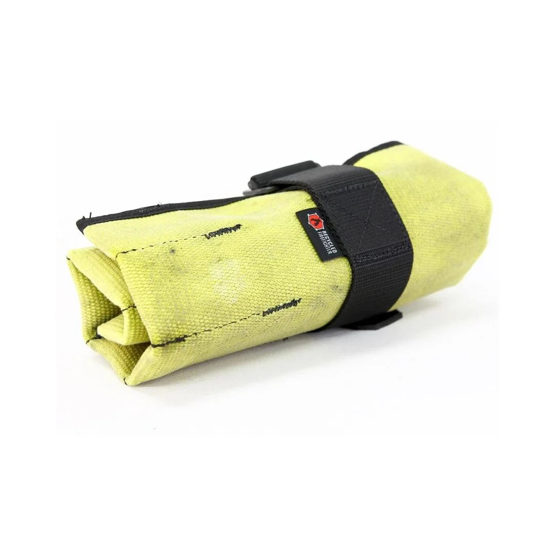 Vintage Yellow Fire Hose Tool Roll from Recycled Firefighter, showcasing the unique scuffs and character of real retired fire gear. This heavy-duty roll is box-stitched at all stress points to ensure a lifetime of reliable tool storage.