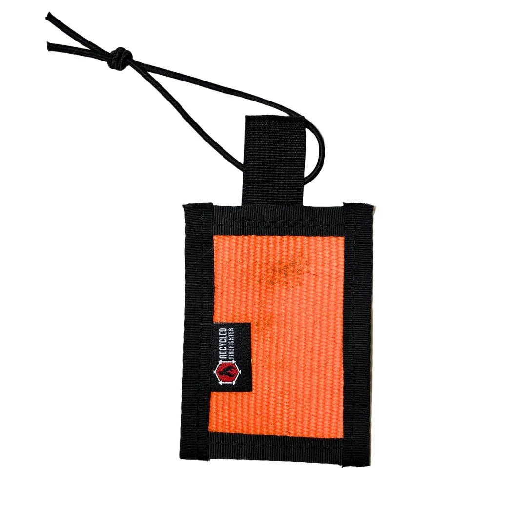 Rugged orange firehose luggage tag featuring unique service marks and reinforced mil-spec binding by Recycled Firefighter.