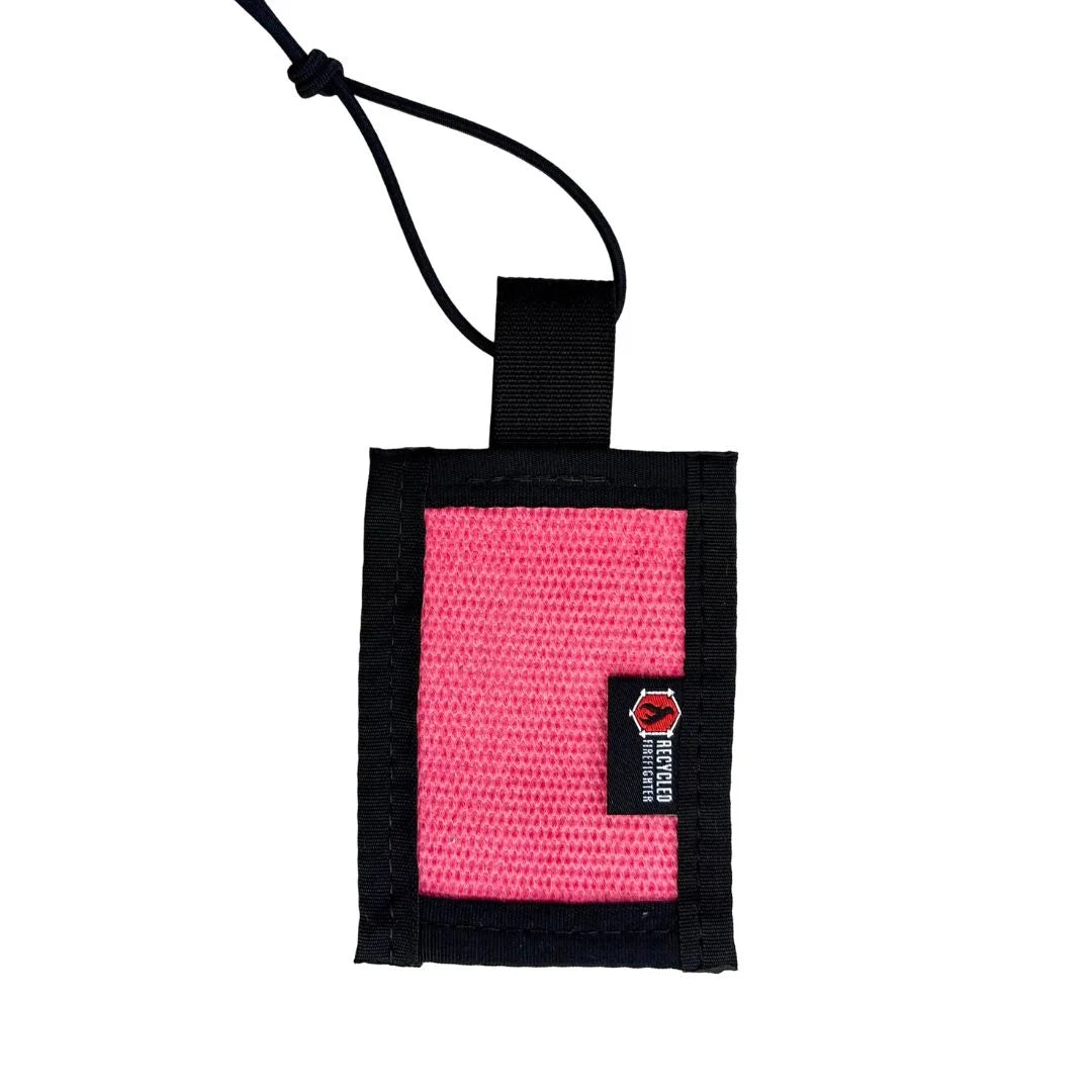 Durable pink repurposed firehose luggage tag with elastic fastening cord for secure gear identification by Recycled Firefighter.
