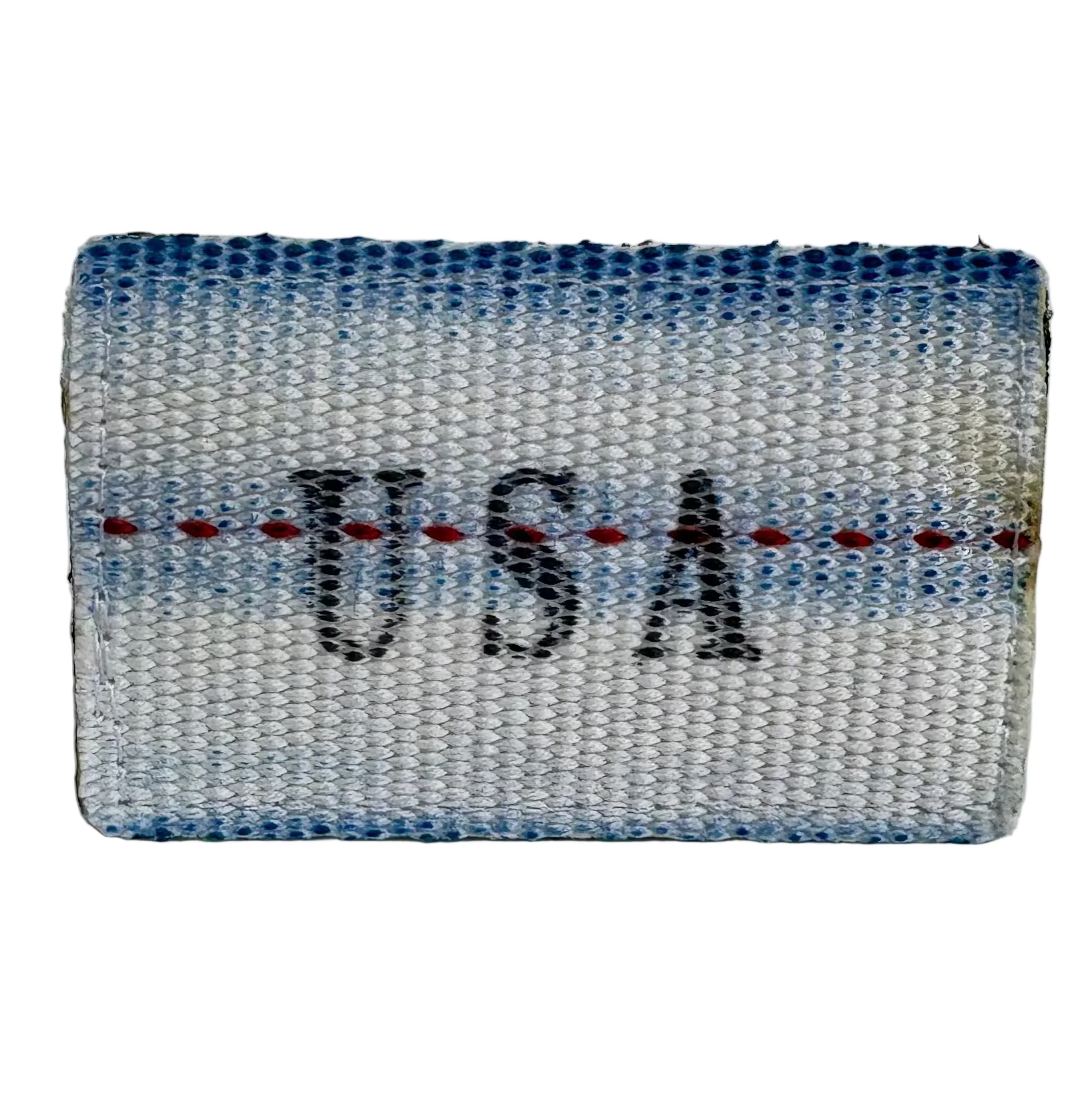 Firehose Patch detail view — reclaimed fire hose material with stitched Recycled Firefighter branding, hook-and-loop back.