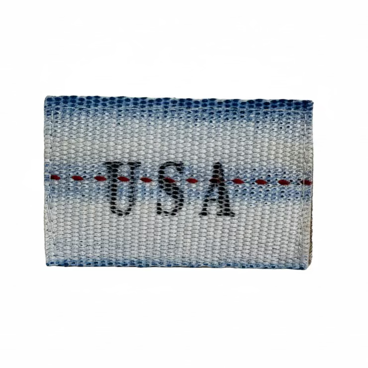'Merica Firehose Patch detail view — limited-edition American flag patch on real fire hose with Mil-Spec stitching, hook-and-loop back.