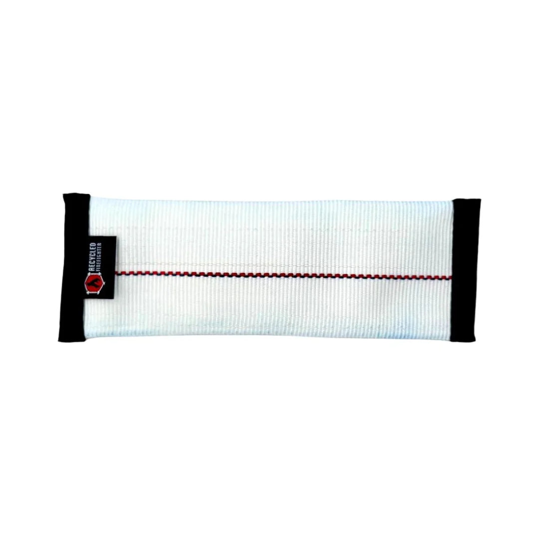 A small, durable dog fetch toy from Recycled Firefighter made from white repurposed fire hose with reinforced black mil-spec binding and heavy-duty stitching.