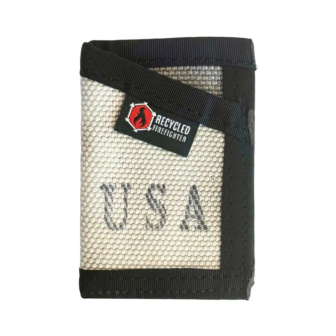 This White Sergeant Wallet Firehose Edition from Recycled Firefighter showcases a clean aesthetic with a black elastic band.