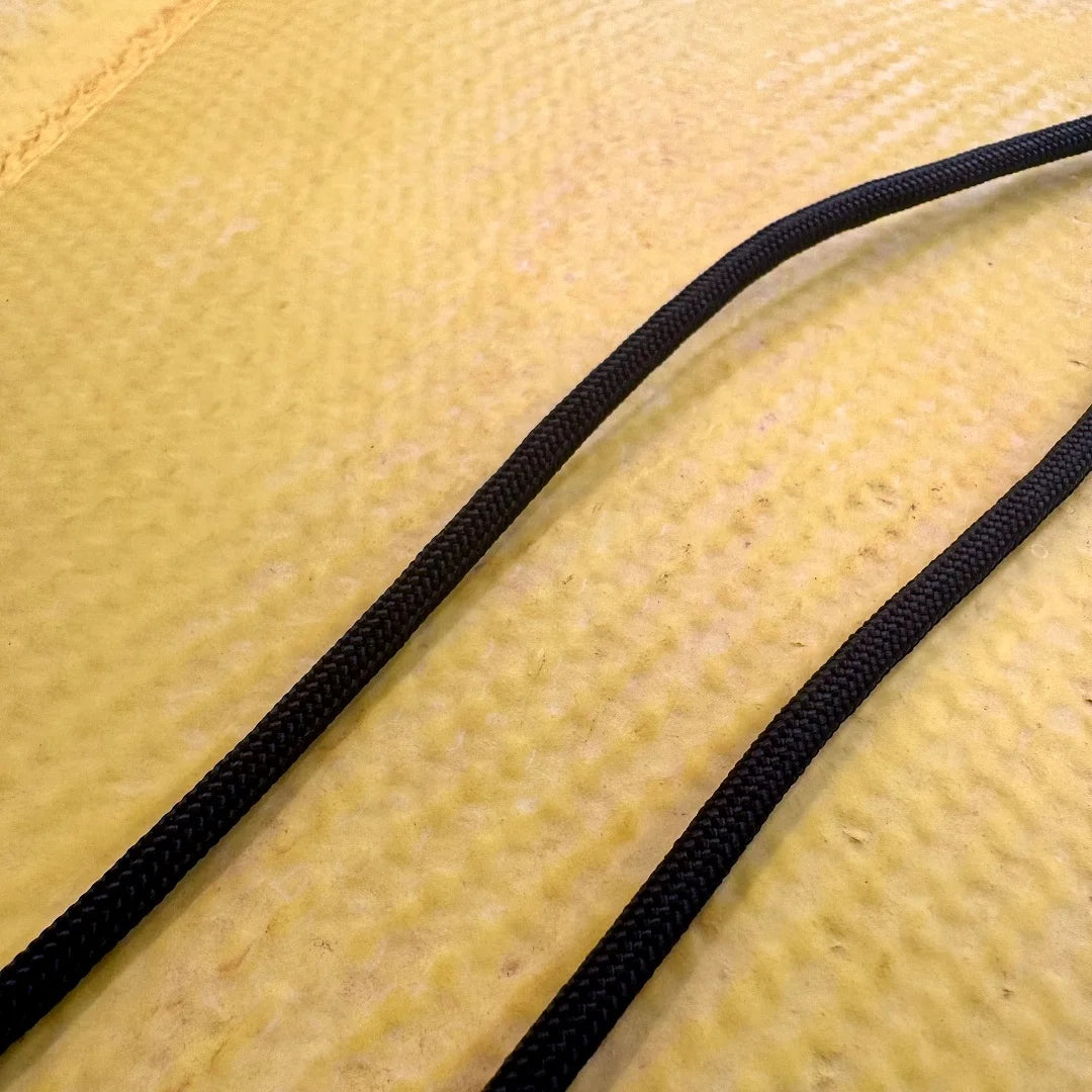 A heavy-duty Drop Zone Mat HD Attack Hose Edition made from repurposed yellow fire hose provides a durable, oil-resistant work surface for firearm maintenance and gear organization.