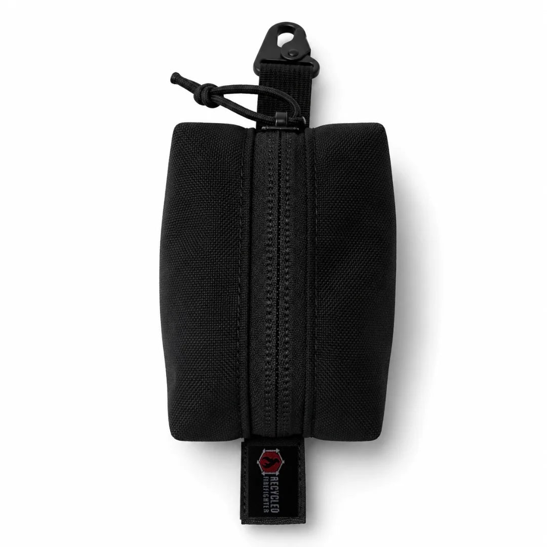 The all-black Hot Shot Commander Keychain Pouch by Recycled Firefighter is a sleek, tactical EDC organizer engineered for rugged daily use. A durable zip closure and integrated metal clip allow instant, secure attachment to keys, belt loops, or backpack straps.