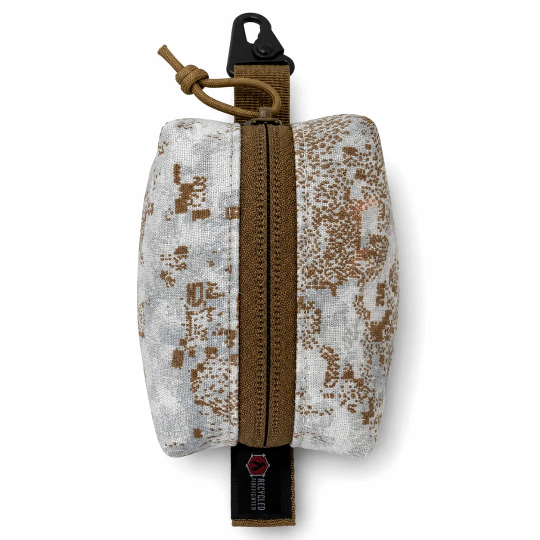 The PenCott Snowdrift Hot Shot Commander Keychain Pouch by Recycled Firefighter wraps a compact EDC clip pouch in a high-performance winter concealment pattern built for cold-weather tactical carry. USA-handcrafted with a secure zipper and metal clip for reliable everyday attachment.