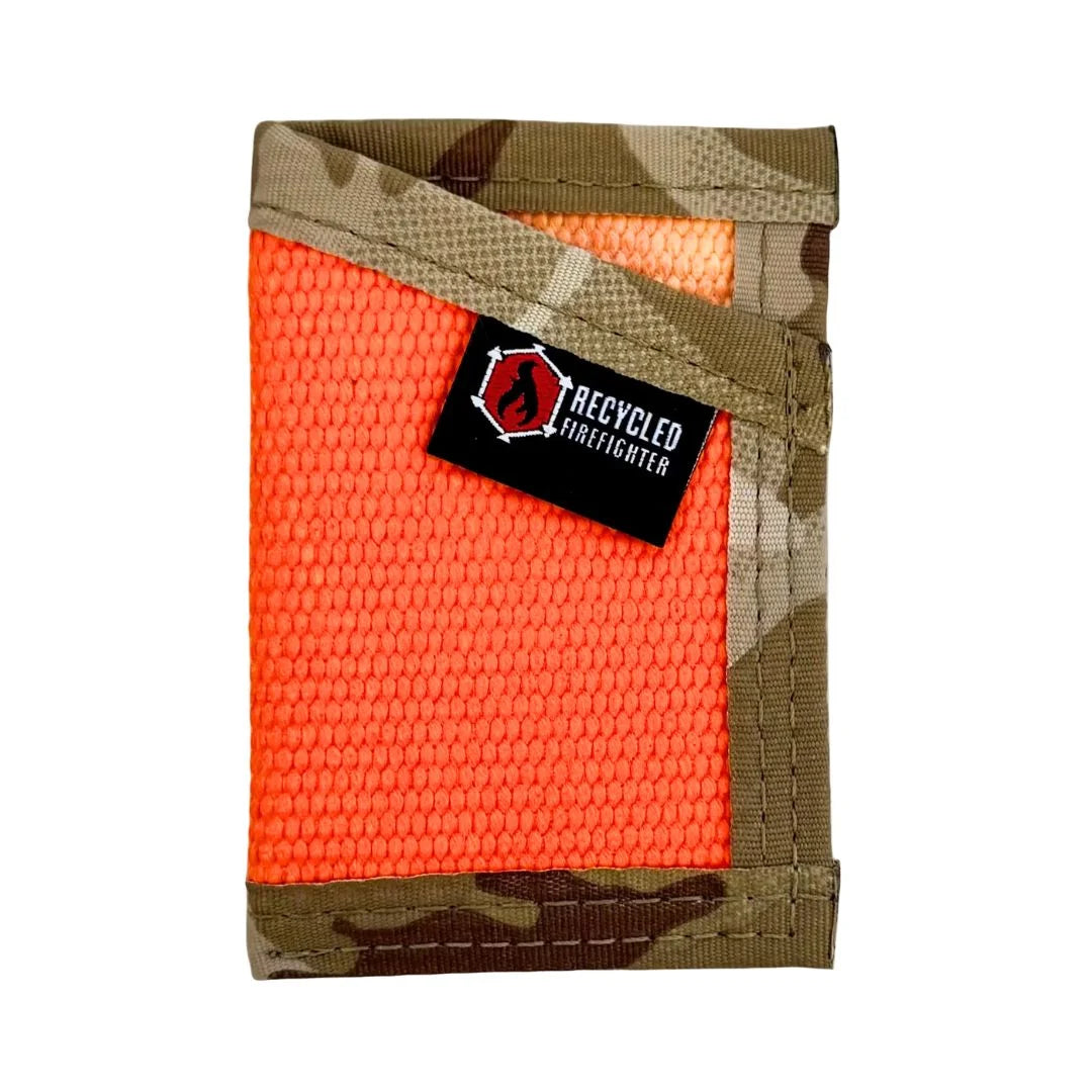 A Recycled Firefighter 'The Sergeant' slim front-pocket wallet made from decommissioned orange fire hose with a Multicam Arid desert camouflage elastic cash strap and black nylon edging.