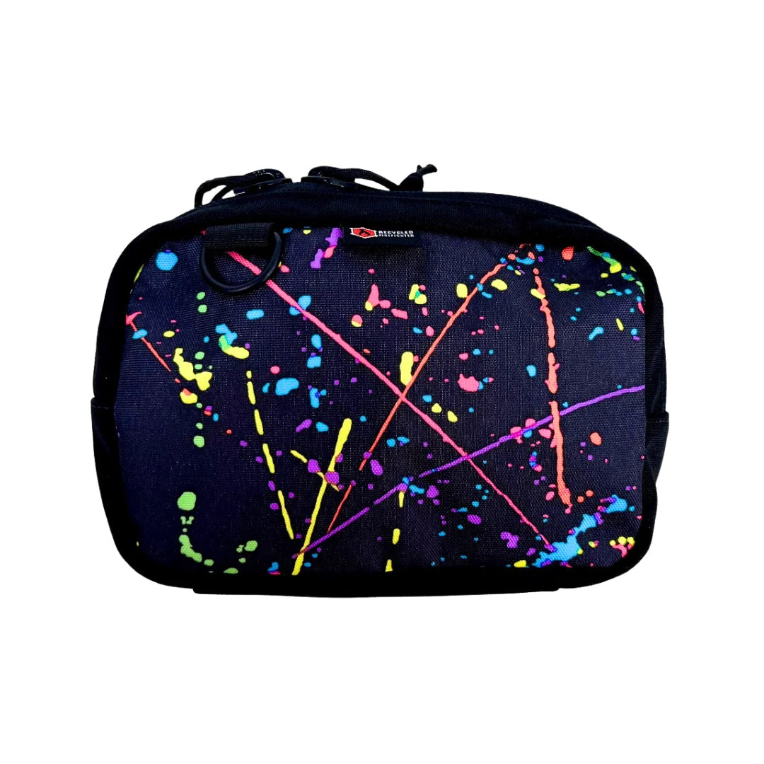 Artistic splatter pattern TrailHound Fanny Pack. Recycled Firefighter's unique 500D design combines style with tactical function.