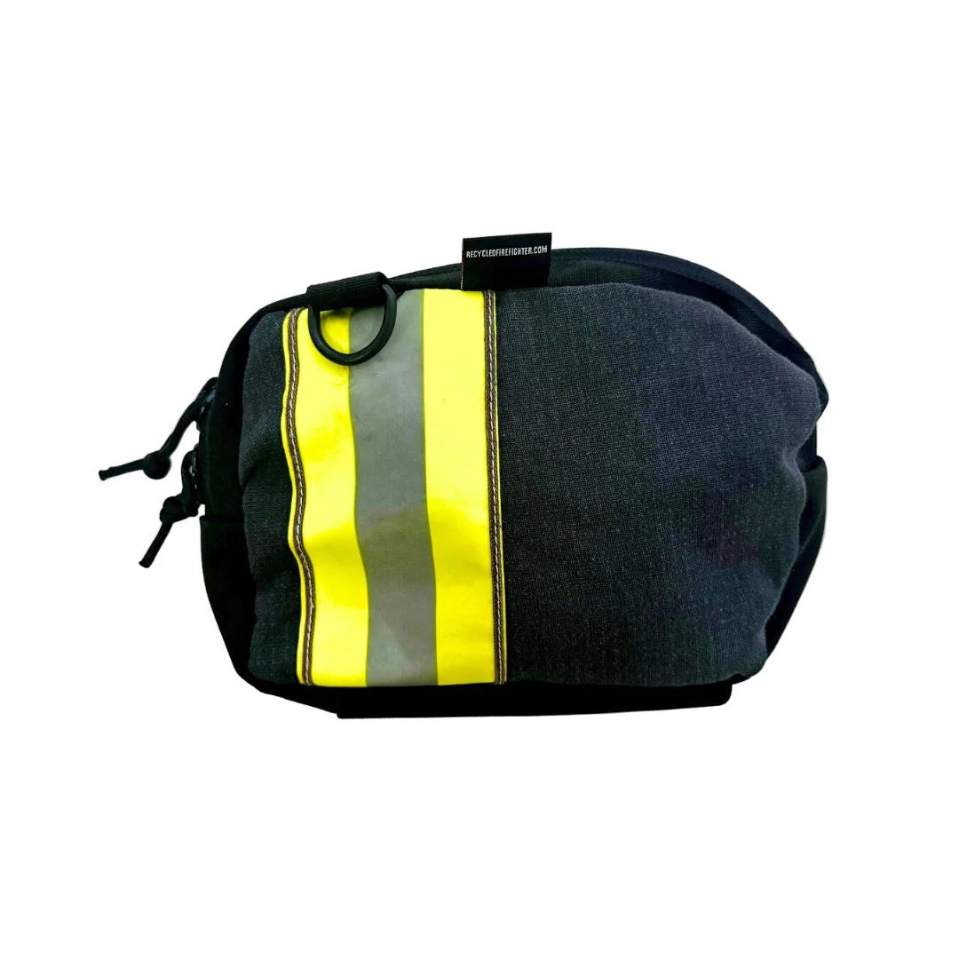 Black repurposed firefighter bunker gear fanny pack by Recycled Firefighter, accented with a vertical yellow and silver reflective safety stripe. The durable material has a textured, fire-resistant finish with heavy-duty black YKK zippers.