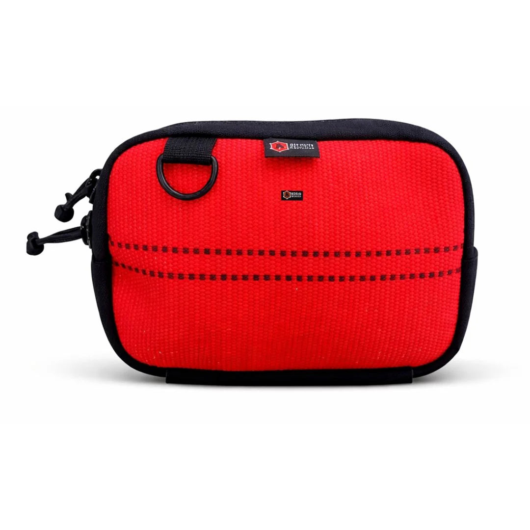 A vibrant red firehose fanny pack by Recycled Firefighter. This variant uses clean, bright decommissioned firehose material for a bold look, accented by a black YKK zipper and a tactical elastic gear loop on the bottom.